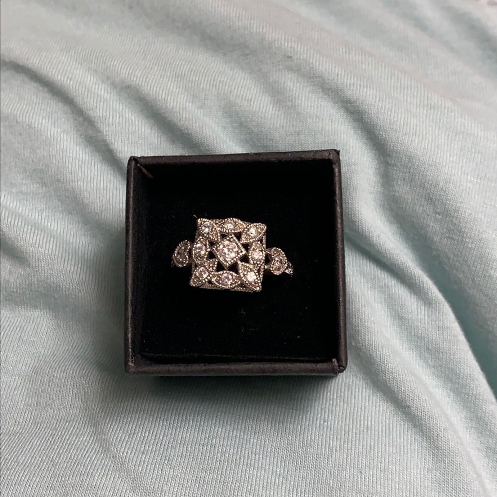 Silver with cubic zirconia accents.